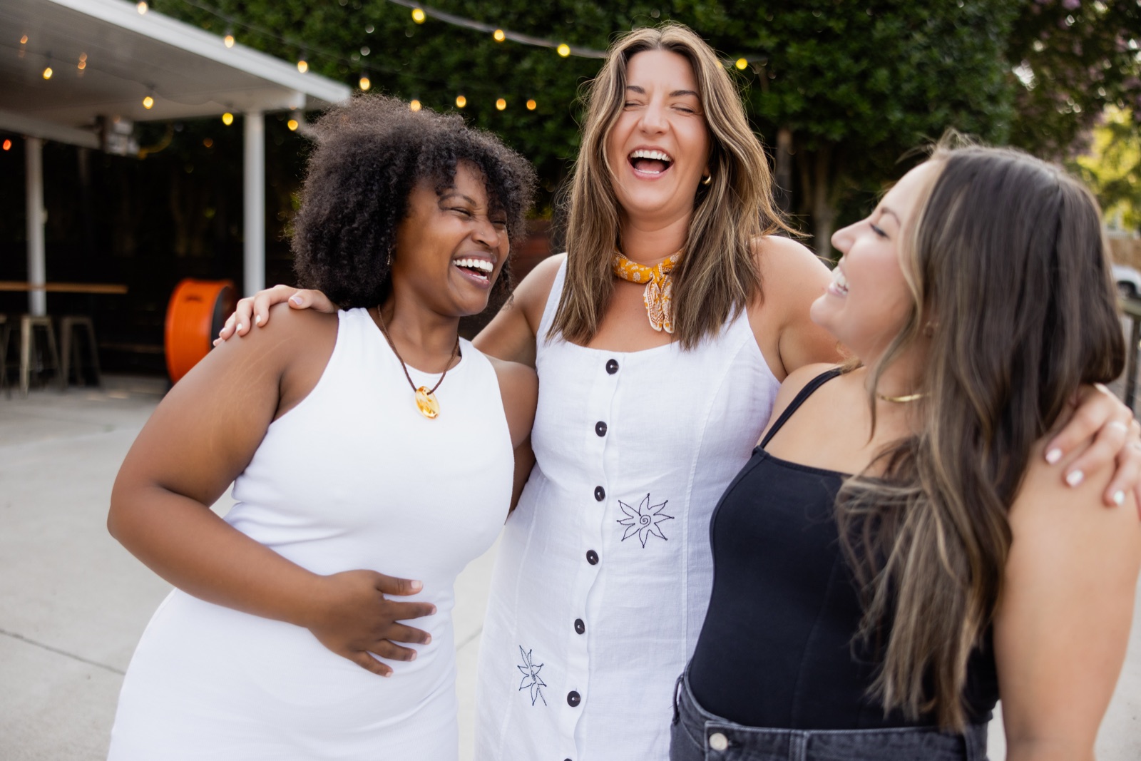 Three Offline Members laughing together outside a restaurant