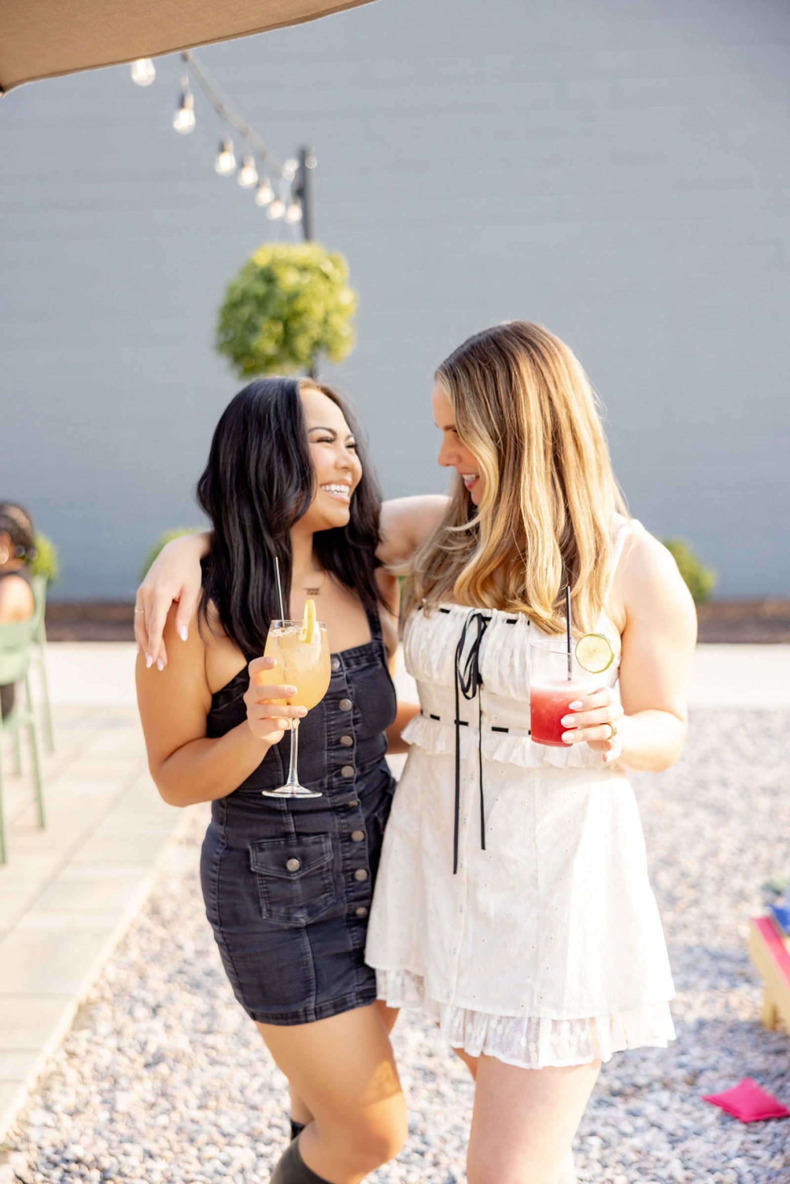 Two Offline Members laughing together with drinks outside